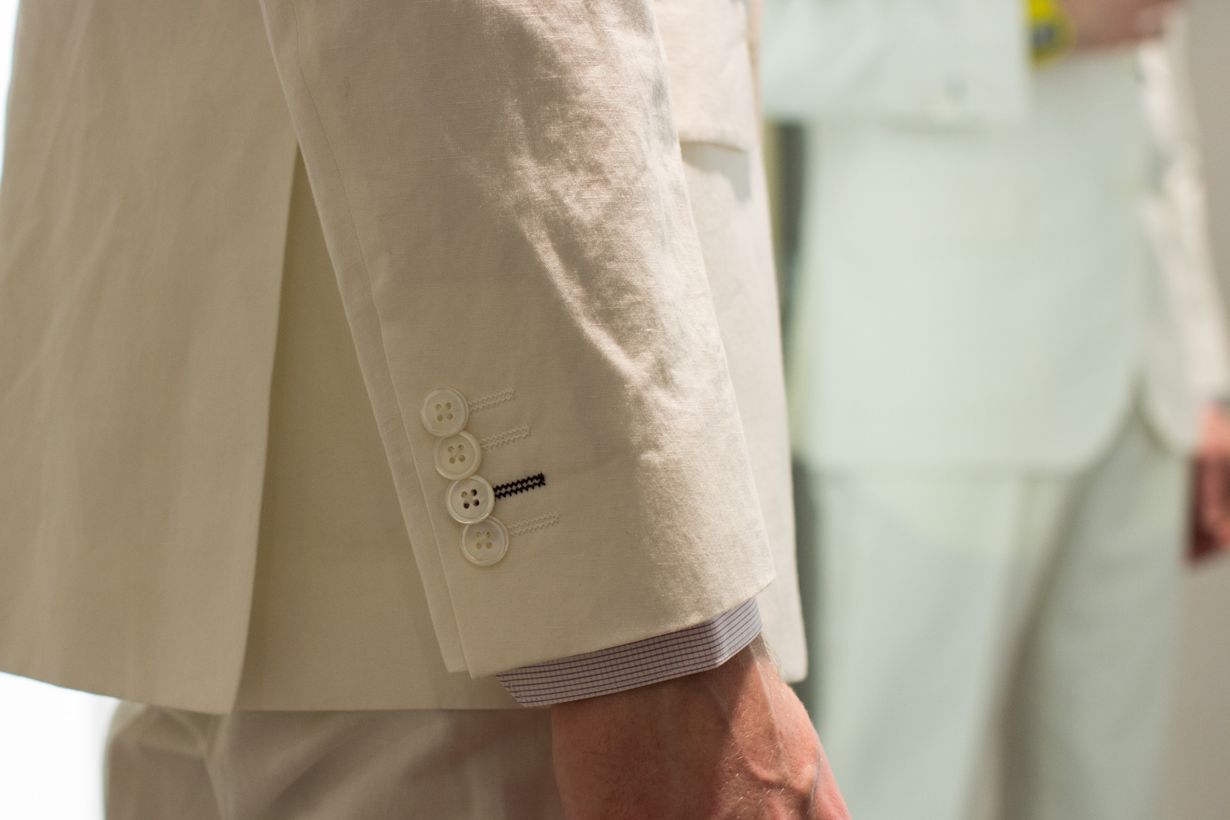 Cuff details on white linen suit at Paul Smith Cuff details on white linen suit at Paul Smith